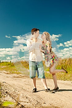 Happy young adult couple in love on the field. Two, man and wom