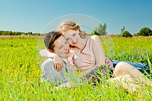 Happy young adult couple in love on the field. Two, man and wom