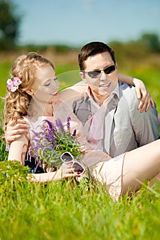 Happy young adult couple in love on the field. Two, man and wom