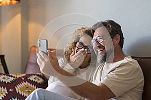 Happy Young Adult Couple Making Video Call On Phone - cheerful people speak and listen friends online with cellular from home