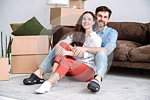 Happy young adult man and woman move in new rent house together