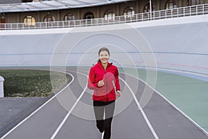 Young adult sporty girl  running on sport training in city