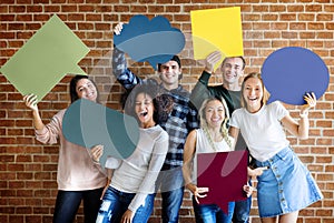 Happy young adults holding empty placard thought bubbles copyspa