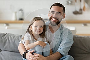 Happy young affectionate dad bonding with little child girl.