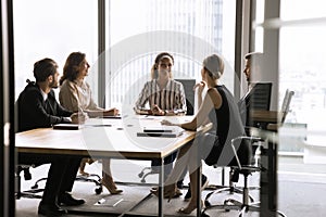 Happy young African American business leader woman holding brainstorming meeting