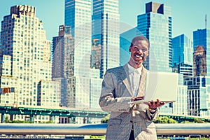 Happy Young African American Businessman traveling, working in N