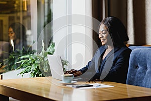 Happy young african american businesswoman using computer in office