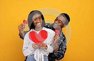 Happy young african american couple in love with hearts have fun together