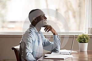 Happy young african american guy visualizing future, weekend or vacation time.