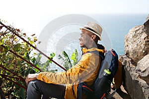 Happy young african american male traveler relaxing outdoors