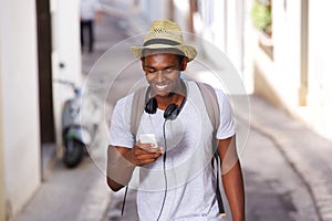 Happy young african american man walking mobile phone