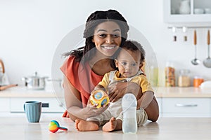 Happy Young African American Mother And Cute Toddler Baby Posing In Kitchen