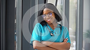 Happy young african american woman doctor with stethoscope looking at camera. Smiling female physician posing in