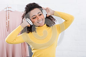 Happy young african american woman listening music