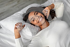 Happy young African American woman posing after wake up