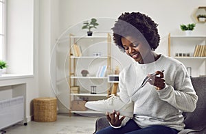 Happy young African American woman puts an orthotic insole in her orthopedic shoes