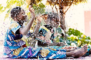 Happy young African Black Girls Friends partying with confetti on the floor