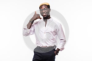 Happy young african man with calling gesture over white background