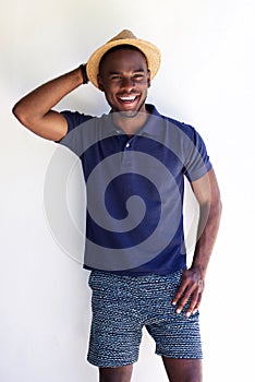 Happy young african man in shorts and hat