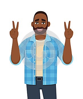 Happy young African man showing victory, peace, V or winning gesture with both hands. Trendy bearded person making success sign.