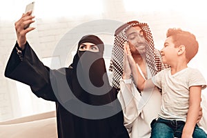 Happy Young Arabian Family Taking Selfie at Home