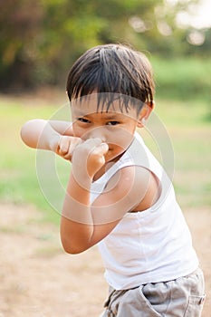 Happy young asia boy playing kungfu having fun