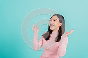 Asian beautiful woman smiling wear silicone orthodontic retainers on teeth surprised she is excited screaming and raise hand make