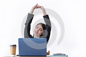 Happy young Asian business woman relaxing with hands behind her head while working in office