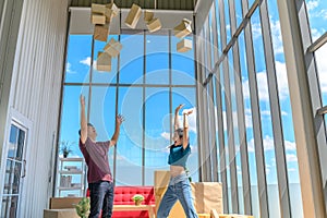 Happy young asian couple smiling relaxing and having fun while playing with cardboard box in new house, moving to new home