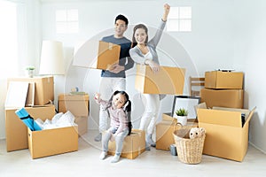 Happy young Asian family moves the boxes to a new home. Moving Concept