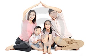 Happy young asian family sitting on floor with home concept