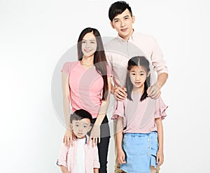 Happy young asian family standing before white background