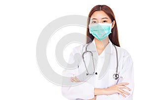 Happy young asian female doctor wear face mask or medical mask and arms crossed with hanging stethoscope around neck. Health care