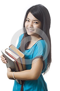 Happy young Asian student holding books