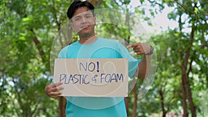 Happy young Asian students diverse volunteers hold a campaign sign for no plastic and foam, Concept of environmental conservation