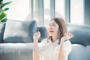 Happy young asian woman holding dollar money and throw in the air celebrate happiness dance wealth lottery money rain drop. Winner