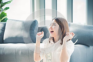 Happy young asian woman holding dollar money and throw in the air celebrate happiness dance wealth lottery money rain drop. Winner