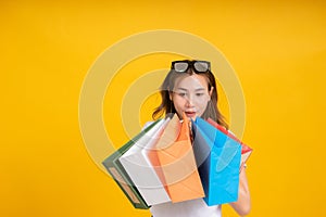 Happy young asian woman with shopping paper bag fashion purchase on store shopping mall