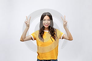 Happy young asian woman showing two fingers or victory gesture with blank copyspace area for text,Portrait of beautiful