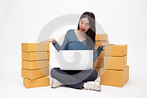Happy young asian woman startup small business freelance with computer laptop and sitting on floor isolated on white background,