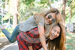 Happy young asian women couple playing to each other while they do city trip.