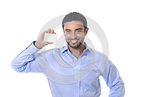 Happy young attractive businessman holding blank business card with copy space