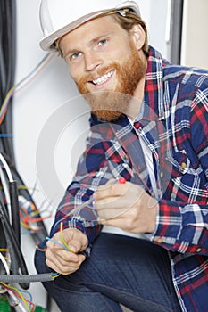 happy young attractive fixing socket cables