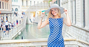Happy young attractive woman fashion model of venice italy in blue polka dot outfit
