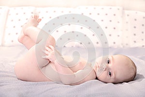 Happy young baby lying on a white background