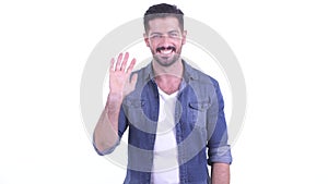 Happy young bearded hipster man waving hand