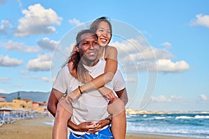 Happy young beautiful couple having fun on the beach.