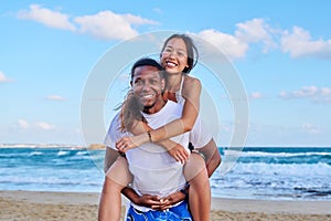 Happy young beautiful couple having fun on the beach.