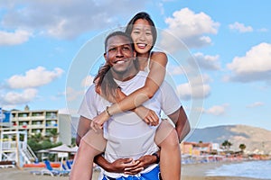 Happy young beautiful couple having fun on the beach.