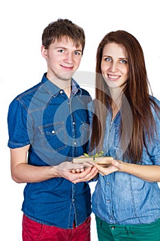 Happy Young beautiful Couple isolated on a White background with gift in hand